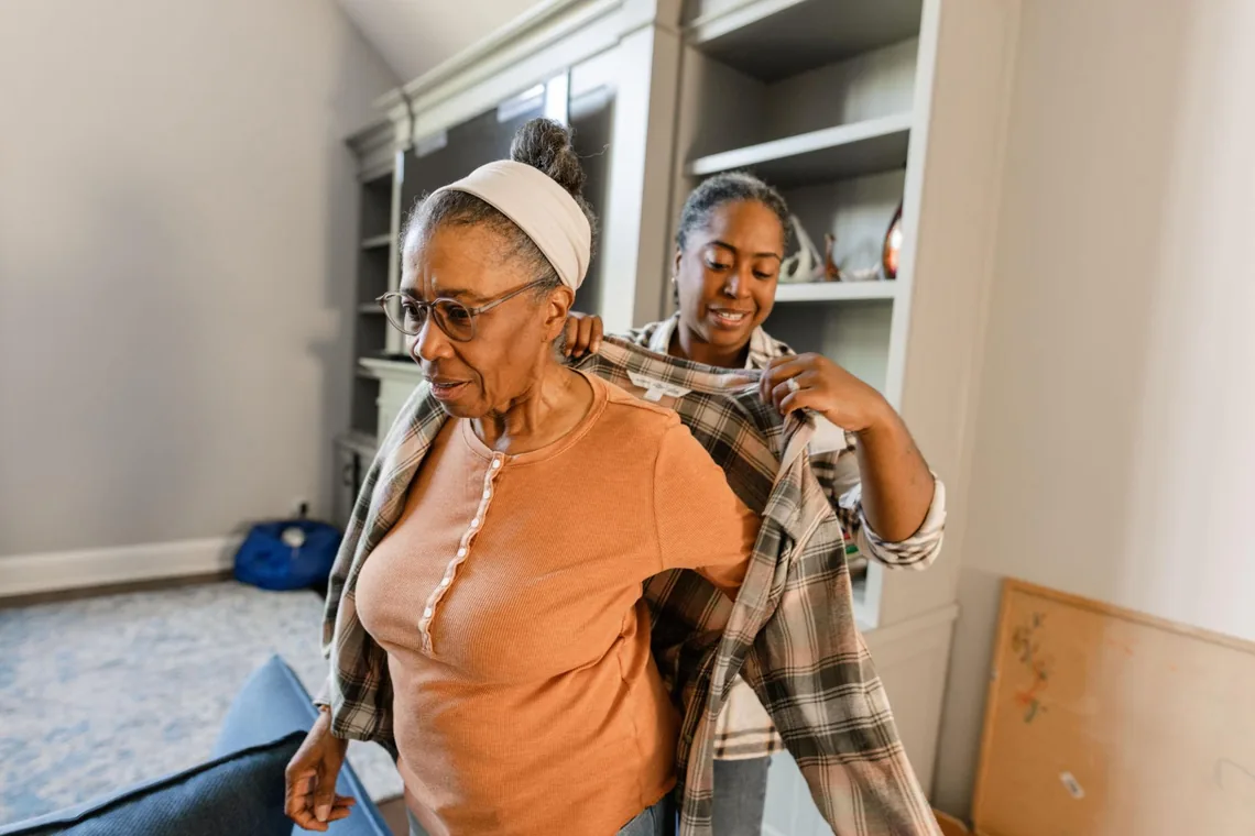 Caregiver assisting with daily dressing support